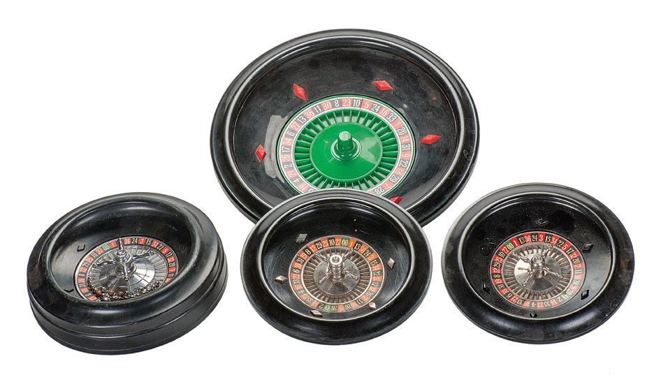 Four Home Game Roulette Wheels. Manufacturer unknown.: Four Home Game Roulette Wheels. Manufacturer unknown. Contemporary. Three are plastic and one is a heavy bakelite. Twelve small metal balls and one layout included. Very good.