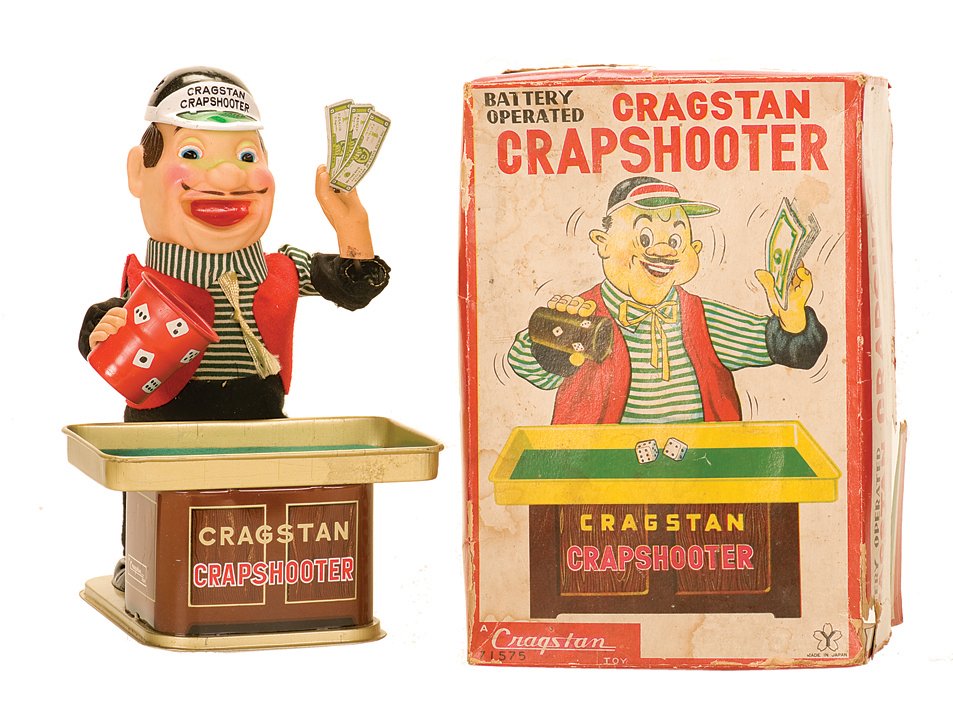 Cragstan Crapshooter wind-up toy. Japan, Cragstan Toys.: Cragstan Crapshooter wind-up toy. Japan, Cragstan Toys, ca. 1955. Toy crapshooter shakes dice in a cup, and rolls them to the table in front of him while shaking a handful of money. Vinyl face, tin ba