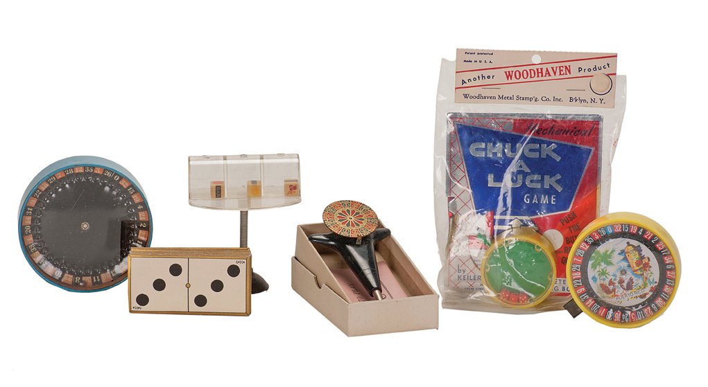 Six gambling-themed items. Autogiro pocket game, etc.: Six gambling-themed items. Autogiro pocket game, two Roulette pocket games, two dice pocket games, and one 1900-era deck of domino cards. Generally good condition.