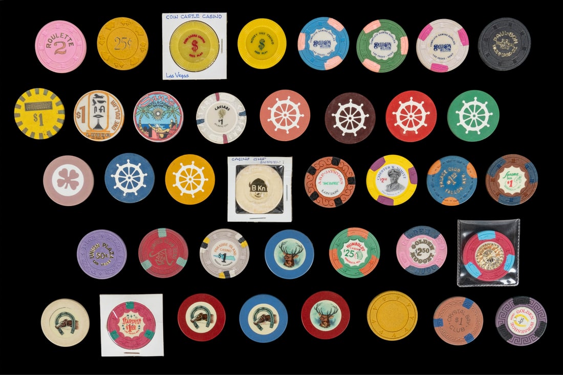 An Album of Casino and Poker Chips and Tokens. Over 225 chi...: An Album of Casino and Poker Chips and Tokens. Over 225 chips and tokens, and several souvenir keychains, organized in a three-ring binder. Includes chips from casinos in Las Vegas, Nevada, Bahamas, L