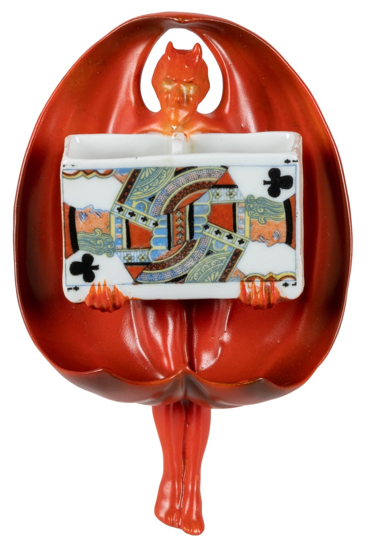 Royal Bayreuth Devil & Cards Match Holder. Figural hanging ...: Royal Bayreuth Devil & Cards Match Holder. Figural hanging match holder of the devil holding a box showing the Jack of Clubs. Blue mark. 5 ¾ x 4 x 1 ½”. Near fine.