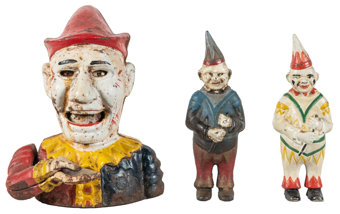 Three Cast Iron Clown Banks. Including a mechanical clown b... (1 of 4)