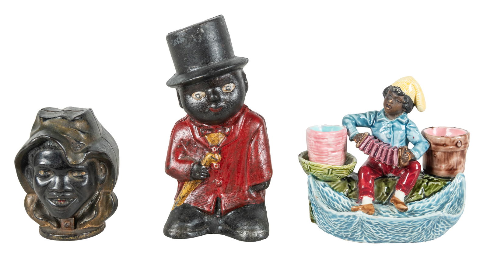 Two Black Americana Cast Iron Banks. Including “Sambo” bank...: Two Black Americana Cast Iron Banks. Including “Sambo” bank, height 7” (older repainting); and a “two-face” bank depicting a boy with hat, height 4 ¼”.