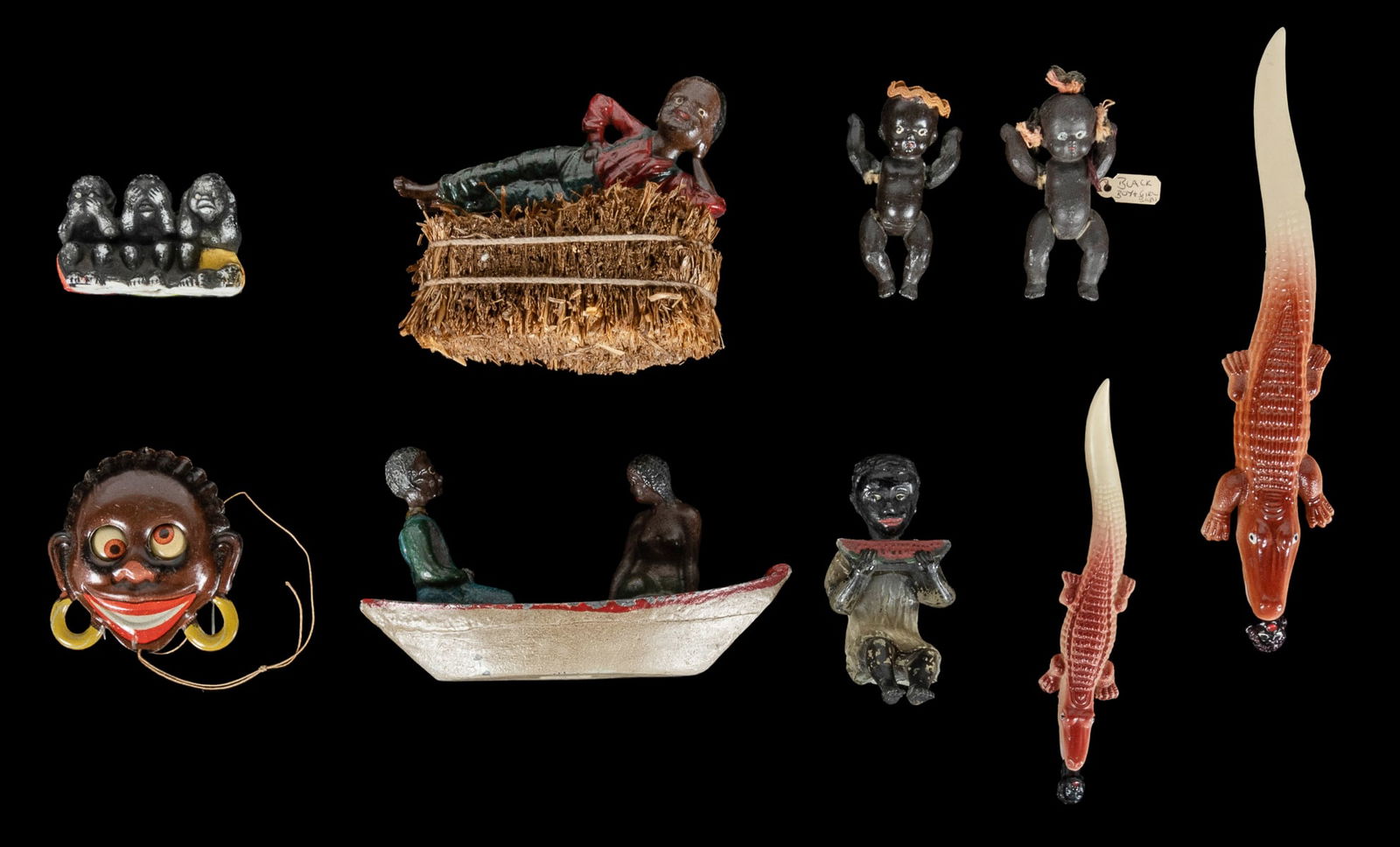 [BLACK AMERICANA]. Group of 9 figures. Circa early to mid-2...: [BLACK AMERICANA]. Group of 9 figures. Circa early to mid-20th century. Includes: cast iron reclining figure on straw; painted glass child with watermelon; cast iron man and mermaid in canoe; One