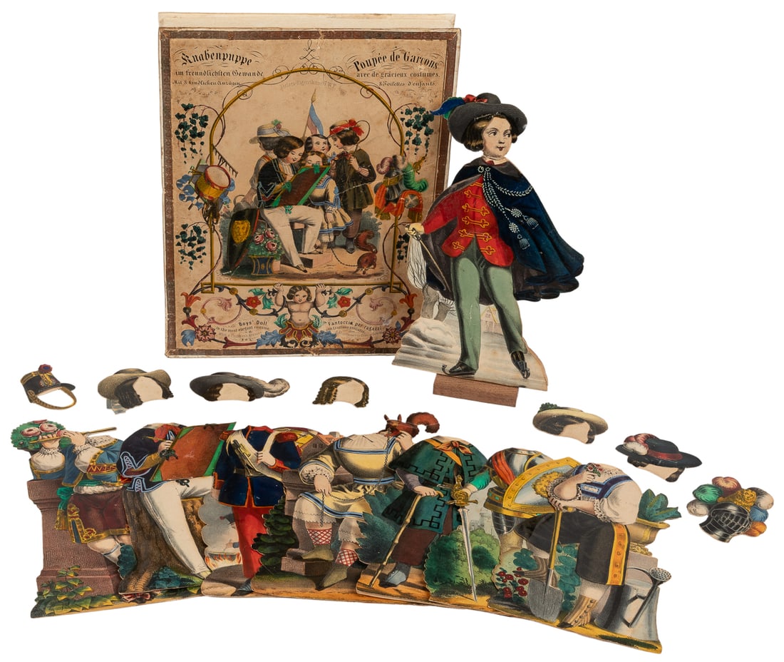 [PAPER DOLLS]. Boys’ Doll in the most elegant costume. Germ...: [PAPER DOLLS]. Boys’ Doll in the most elegant costume. Germany, ca. 1850. Complete set includes one cardstock boy figure with eight slip-over costumes and accompanying hats. Paste-down