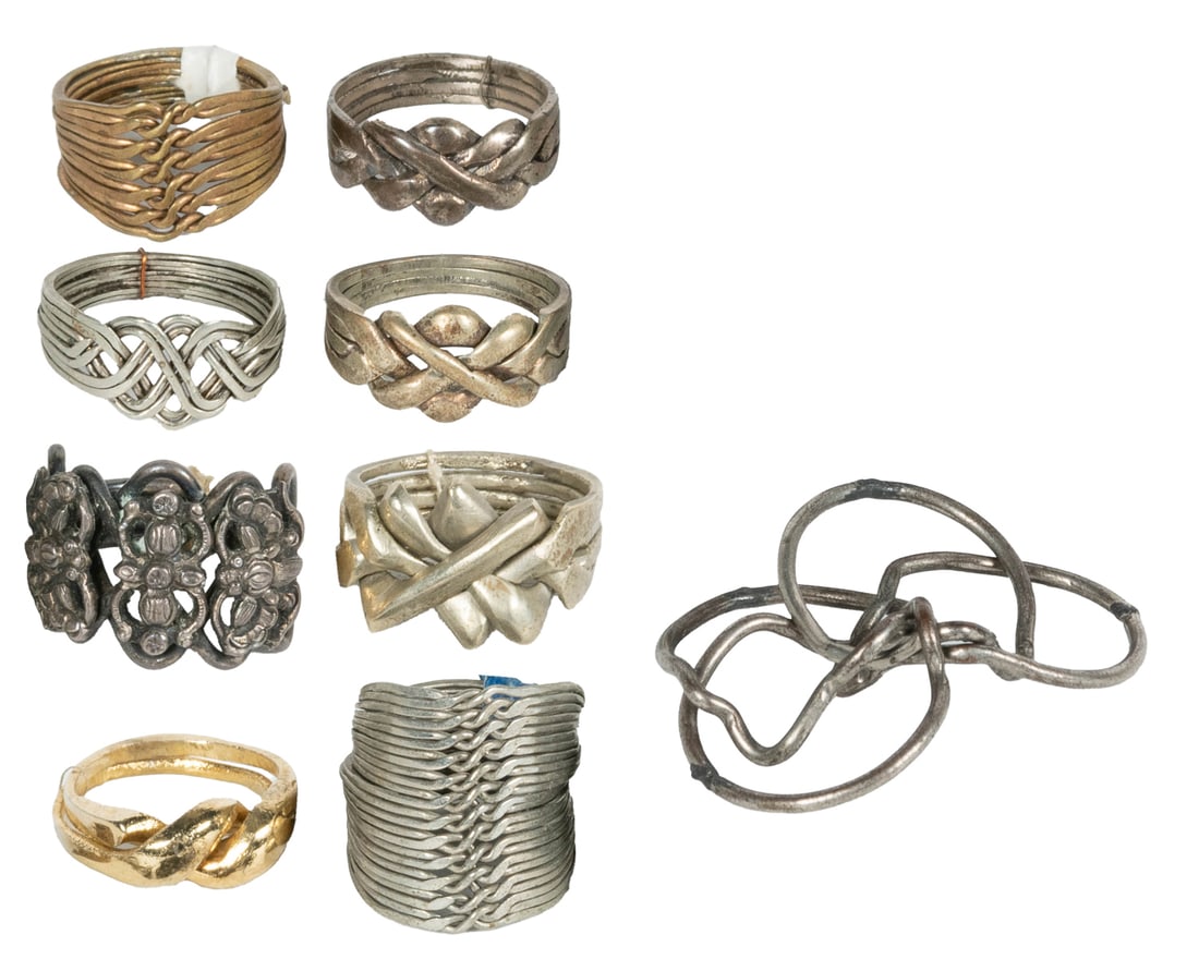[JEWELRY]. Lot of 13 Puzzle Rings. Circa 1940s–1970s. Colle... (1 of 2)