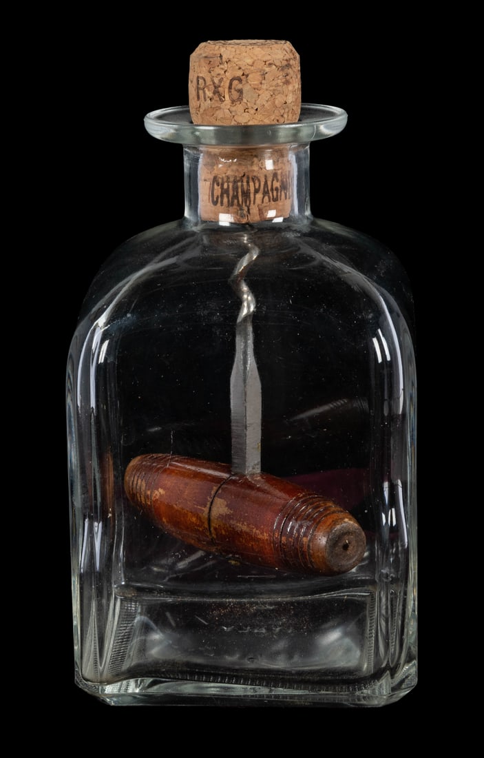Corkscrewed Impossible Bottle.: Corkscrewed Impossible Bottle. Circa 2010. A square glass bottle with a corkscrew inside – screwed into the cork that stops the bottle’s opening. 4 x 4 x 7 ½”.