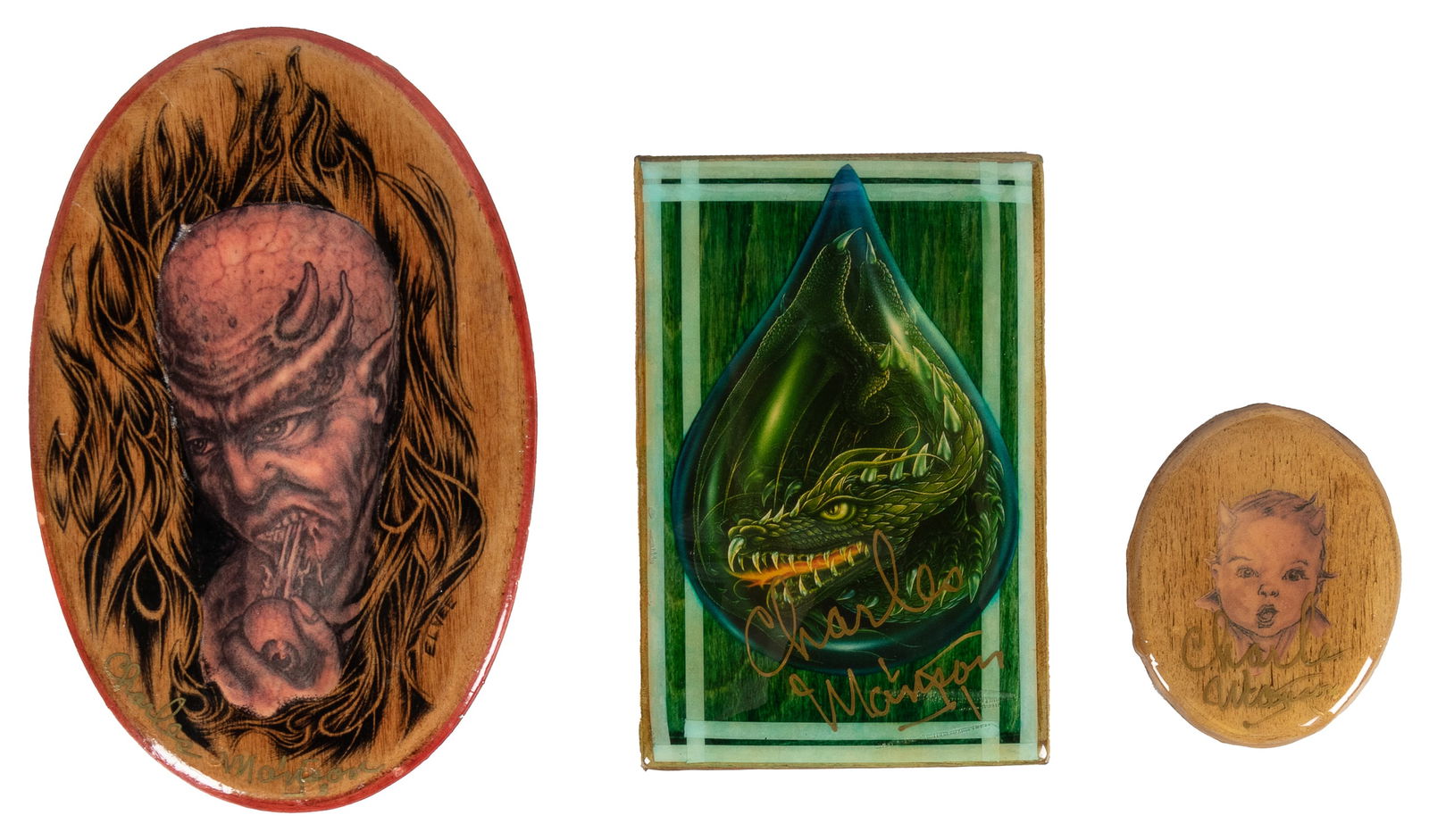 [PRISON ART]. MANSON, Charles (1934-2017). Three Signed Charles Manson Collaged Plaques, Late 20th: [PRISON ART]. MANSON, Charles (1934-2017). Three Signed Charles Manson Collaged Plaques. Late 20th Century. Three collaged images on wood with resin coating. Signed by El Vee as well as Charles