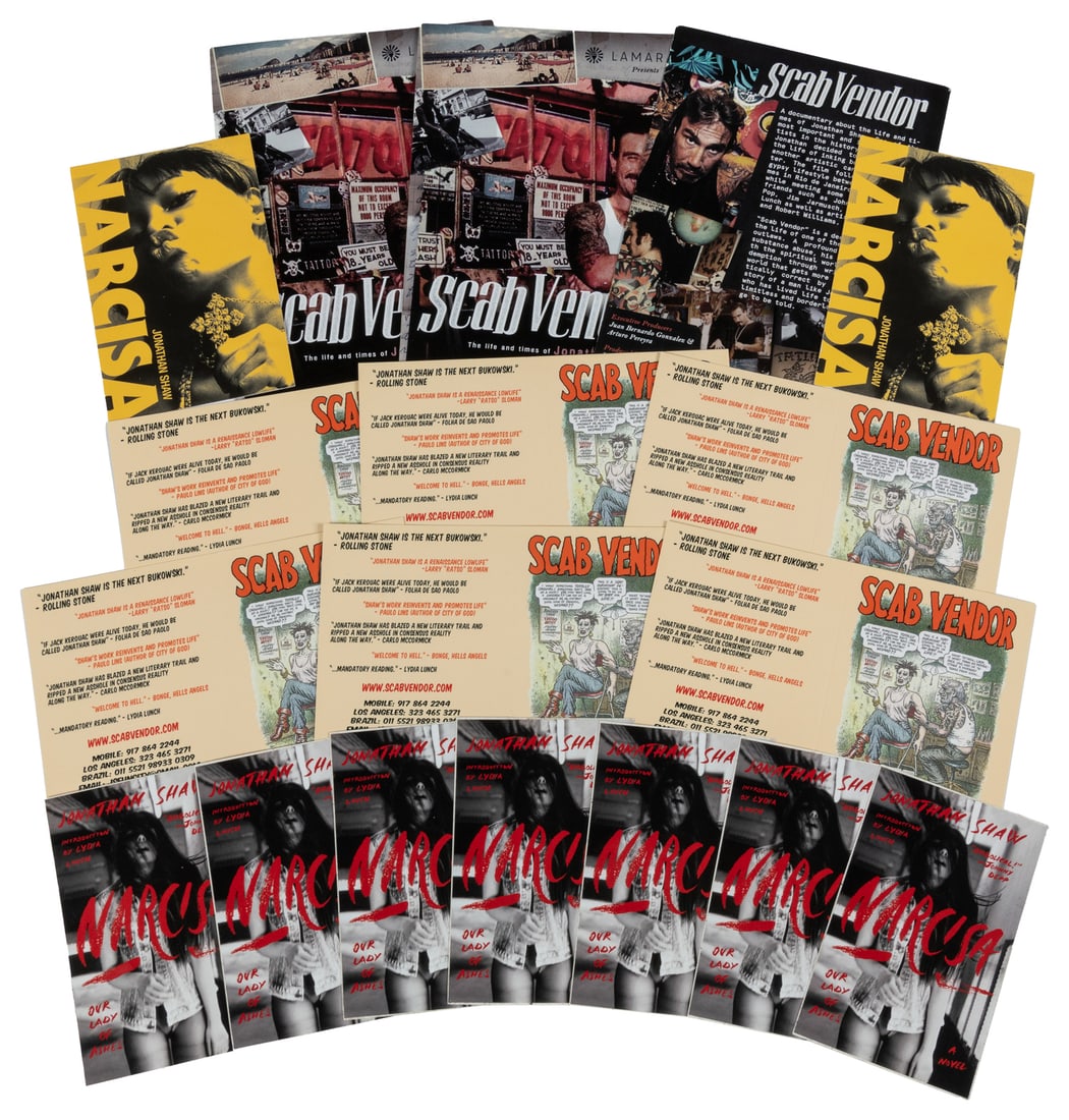 Group of Jonathan Shaw Book and Film Ephemera.: Group of Jonathan Shaw Book and Film Ephemera. Includes 10 small booklets for Scab Vendor, 19 stickers for Narcisa (2008), 10 stickers for Narcisa: Our Lady of Ashes (2015), and 3 fliers for Scab