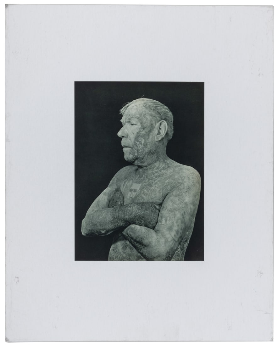 DOISNEAU, Robert (1912 - 1994). Tattooed man - Edmond Faucher, aka Ricardo.: DOISNEAU, Robert (1912 - 1994). Tattooed man - Edmond Faucher, aka Ricardo. 1950s / later printing. Photogravure on medium weight matte-finish paper. 10 5/8 x 7 3/4". Dry mounted to board, 20 x 15 1/2
