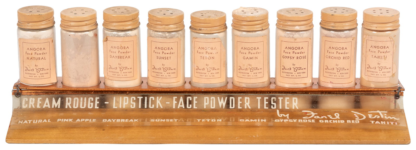 Farel Destin Face Powder countertop sample display.: Farel Destin Face Powder countertop sample display. Countertop stand with advertising on acrylic panel, holding nine sample bottles of powder (one with torn label). 3 1/2 x 10 1/4 x 2 1/2".