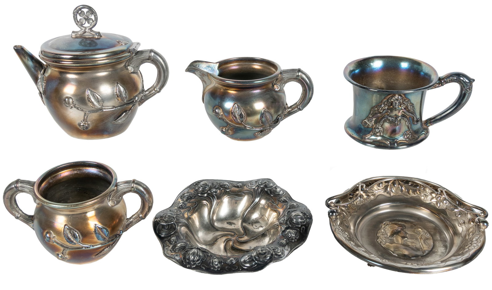 Six Art Nouveau silverplate items.: Six Art Nouveau silverplate items. Including: (3) Wilcox Silverplate tea set; Victor Silver Co. cup; and two trays, one with handle, with indistinct marks. 5 x 6 x 3 1/2" and smaller.