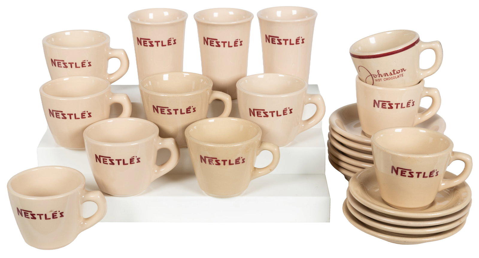 Group of 12 Nestle's and one Johnston Hot Chocolate coffee mugs, plus saucers.: Group of 12 Nestle's and one Johnston Hot Chocolate mugs, plus saucers. Circa 1940s. Nine marked by J.L. Pasmantier & Sons, three Inca Ware; also with a Johnston Hot Chocolate mug by Wellsville China