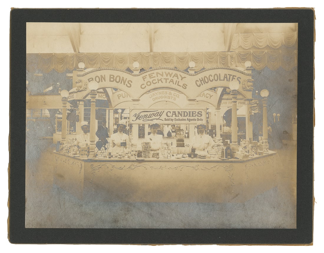 Fenway Candies advertising display photograph.: Fenway Candies advertising display photograph. Old Orchard Beach, ME: Tisdale's Studio, ca. 1900s. Silver print mounted photograph of an elaborate display for Fenway Candies with three women behind th