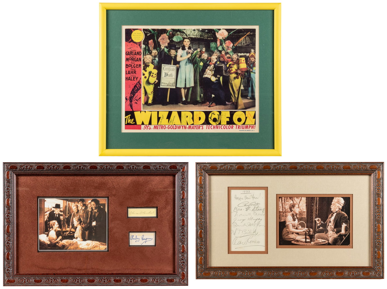 [WIZARD OF OZ]. Collection of autographs in four framed displays.: [WIZARD OF OZ]. Collection of autographs in four framed displays. Four framed displays with 18 total signatures, including:A 1938 New Year card signed by seven actors, including Frank Morgan, Cary