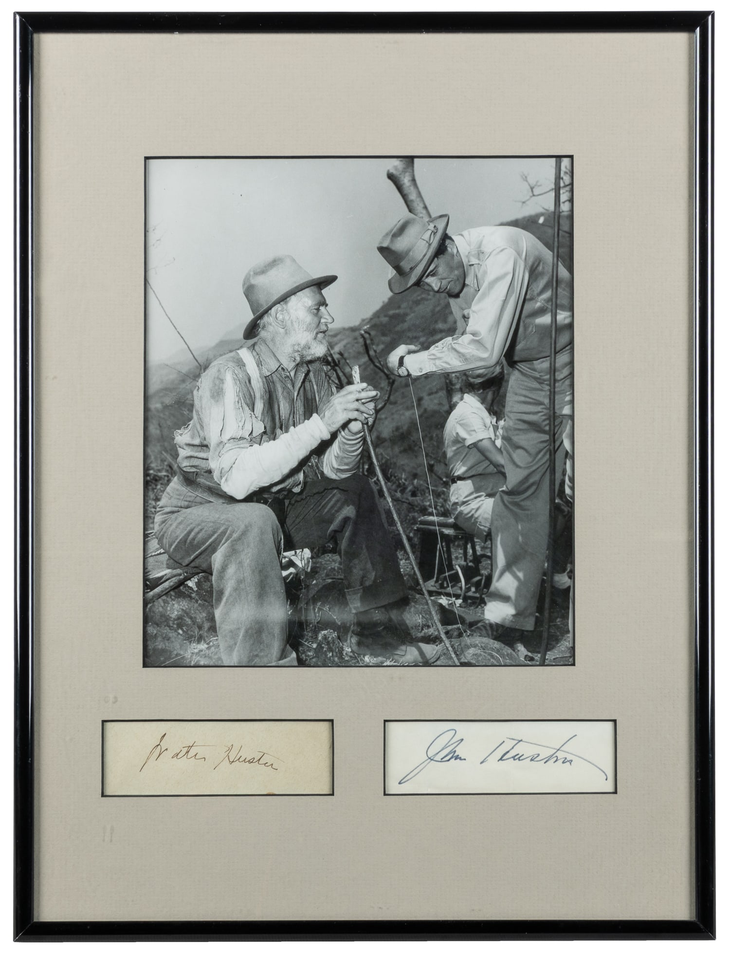 [HUSTON, Walter (1883–1950) and John (1906–1987)]. Signed Behind-the-Scenes Photograph: [HUSTON, Walter (1883–1950) and John (1906–1987)]. Photograph of the Hustons from "The Treasure of the Sierra Madre," matted with autographs. Walter Huston (1883-1950), pictured on the lef