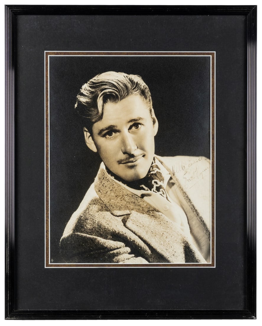 [FLYNN, Errol (1909-1959)]. Signed Studio Portrait. (1 of 2)