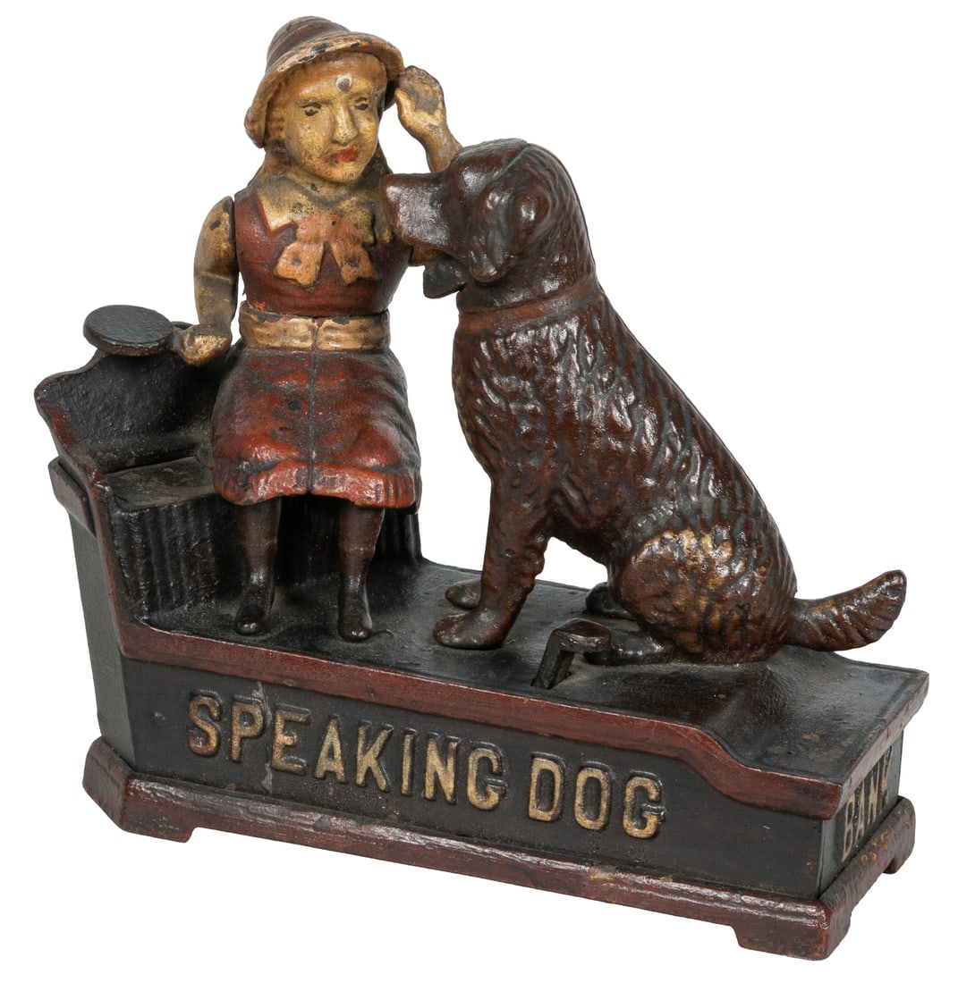 Speaking Dog cast iron mechanical bank.: Speaking Dog cast iron mechanical bank. Shepard Hardware Co. A coin placed on the plate held by the girl falls into the bank when the lever is pressed.7 1/2 x 7 x 3".