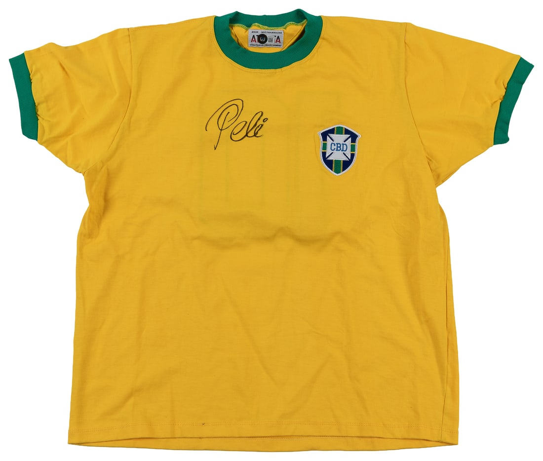 Pele signed Brazil CBD jersey (BAS).: Pele signed Brazil CBD jersey (BAS). Yellow and green soccer jersey, signed at the top front in bold black marker by Pele. With Beckett LOA.27 x 20 1/2".