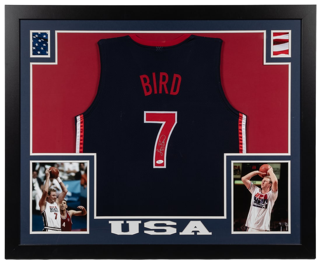 Larry Bird Signed Team USA jersey (JSA).: Larry Bird Signed Team USA jersey (JSA). A #7 navy blue jersey signed by Bird in silver in the jersey number.Framed and matted with two photos of Bird and a laser-cut mat. Overall, 36 x