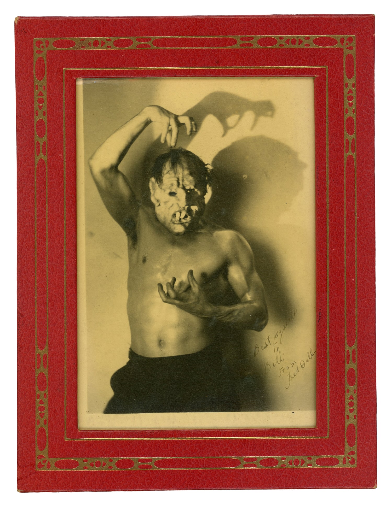 Framed Photograph of Muscular Man in Grotesque Makeup. Circa 1920s.: Framed Photograph of Muscular Man in Grotesque Makeup. Circa 1920s. Single, sepia-toned photograph. Inscribed to the lower right. Frame 6 1/2 x 8 3/4”, photograph 5 x 8”.