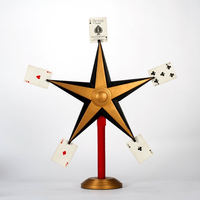 Card Star. Alhambra, Owen Magic Supreme: Card Star. Alhambra, Owen Magic Supreme, ca. 1970. Five selected cards appear on the points of this handsome wooden star when the deck is thrown at it. 22" tall. Good.