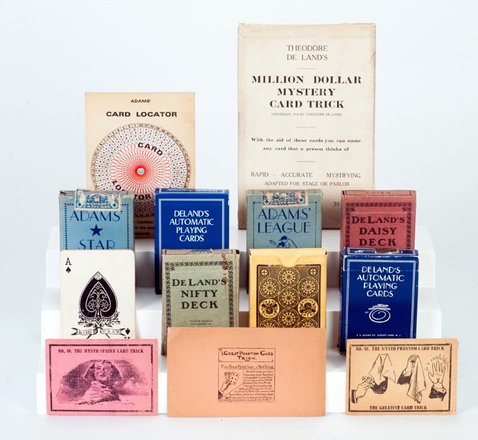 Over 30 vintage Theodore Deland tricks: [Deland, Theodore] Collection of over 30 vintage Theodore Deland trick cards and card tricks. Most manufactured by S.S. Adams Co. of Neptune, New Jersey. Among the effects and decks included are: The 