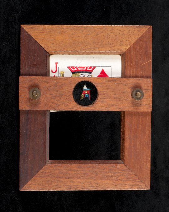 Penetrative Card Frame. F.G. Thayer, ca. 1940: Penetrative Card Frame. Los Angeles, F.G. Thayer, ca. 1940. A playing card pinned to a small hardwood frame is partially covered by a wooden crossbar. A finger or wand can be pushed through the crossb