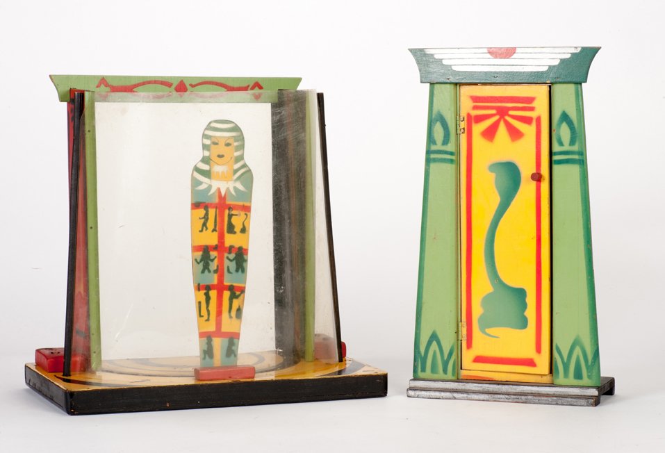Morrell’s Return to Karnac. Ken Brooke’s House / Veroni: Morrell’s Return to Karnac. London, Ken Brooke’s House of Veroni, ca. 1950. A wooden mummy figure is removed from a temple and placed on display some distance away in a “museum.” The mummy is 