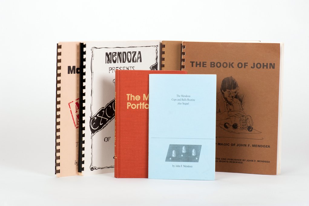 Mendoza, John. Group of six magic books: Mendoza, John. Group of six magic books. Includes The Mendoza Portfolio; The Mendoza Cups and Balls Routine; The Magic of Dan Fleshman; The Excellence of Dan Fleshman; The Book of John; and John: Vers