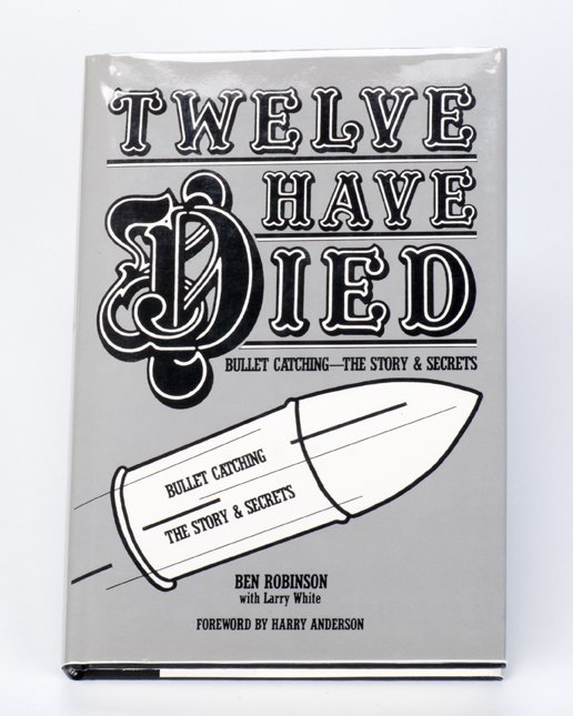 Robinson, Ben (with Larry White). Twelve Have Died…: Robinson, Ben (with Larry White). Twelve Have Died… Bullet Catching, The Story & Secrets. Watertown: Ray Goulet’s Magic Art Book Co., 1986. Black boards with jacket. Illustrated. Signed and inscri
