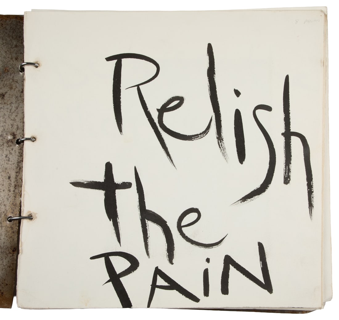 Relish the Pain. N.p., 1990s/2000s. Artist Photo Scrapbook.: Relish the Pain. N.p., 1990s/2000s. Artist-created scrapbook consisting of eight black & white silver gelatin photographs of body piercings paired with hand-painted text overlays on vellum. Bound in s