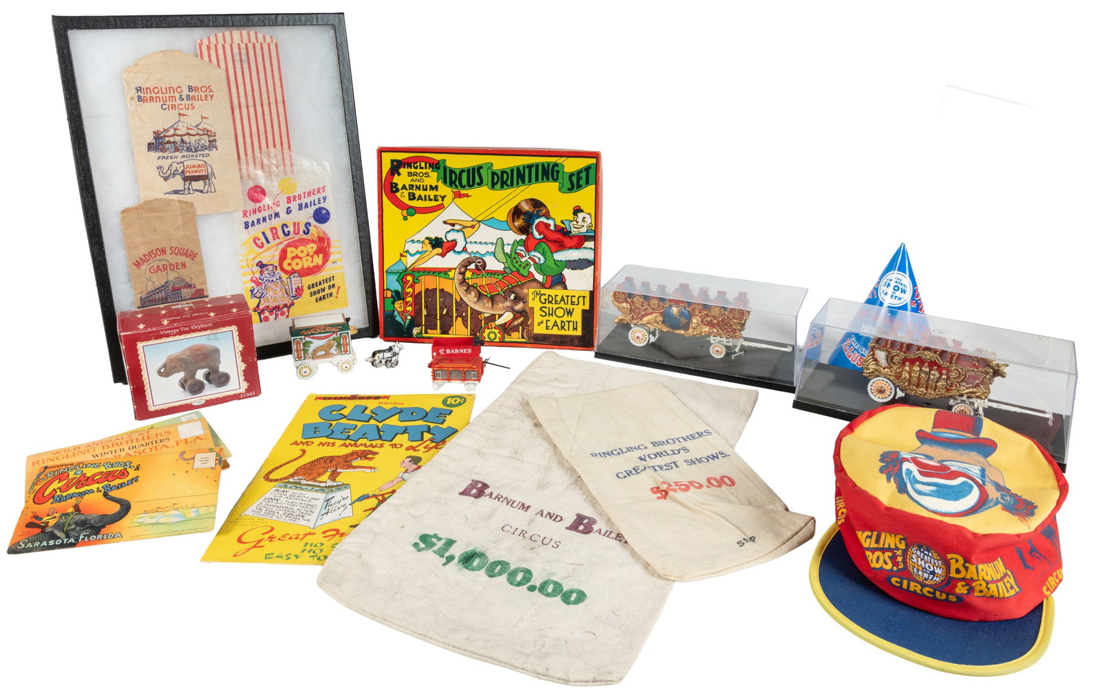 [CIRCUS]. Group lot of circus souvenirs, models, and memorabilia.: [CIRCUS]. Group lot of circus souvenirs, models, and memorabilia. Circa 1950s-2000s. Approximately 30 pieces total, including: 1) A display of four circus popcorn bags. 2) A bin with eight souvenir