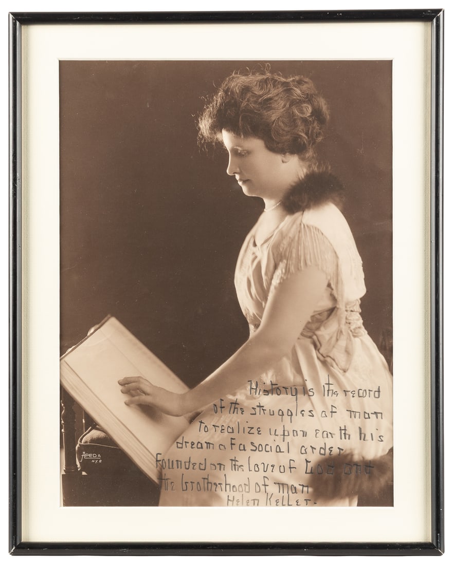 KELLER, Helen (1880-1968). Inscribed Photograph. [New York: Areda, n.d.].: KELLER, Helen (1880-1968). Inscribed Photograph. [New York: Areda, n.d.]. Large black and white photograph of a youthful Keller reading a book in Braille (or another similar type for the blind). Sight