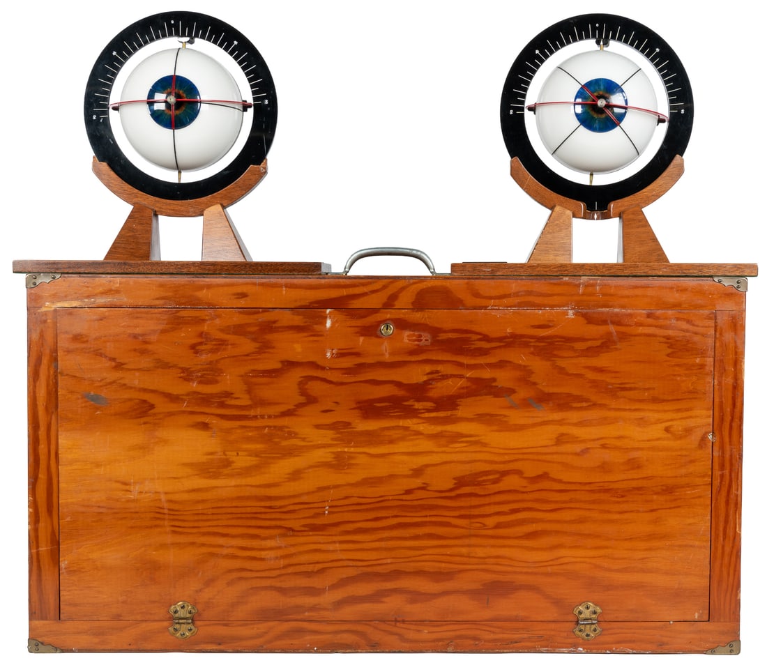 Two Large Eye Demonstration Models: Two Optometrist Large Eye Demonstration Models. 1960s / 1950s. Wood plastic and metal. Stunning design of plastic optometrist's anatomical eye models. Both fit on teak stands and are housed in a