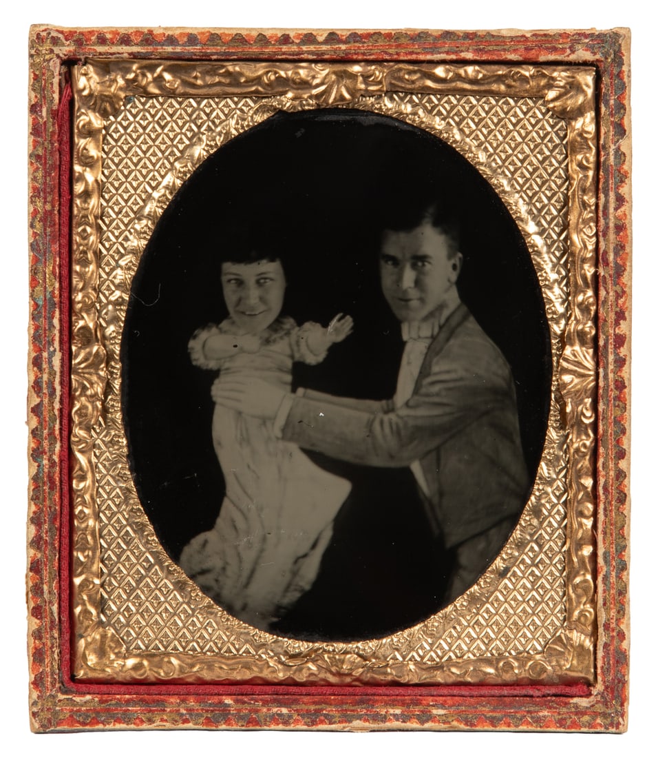 Cased novelty photograph. Circa late 19th century.: Cased novelty photograph. Circa mid-19th century. Trick photo ambrotype of a man holding a baby with the head of an adult woman. Sixth plate.