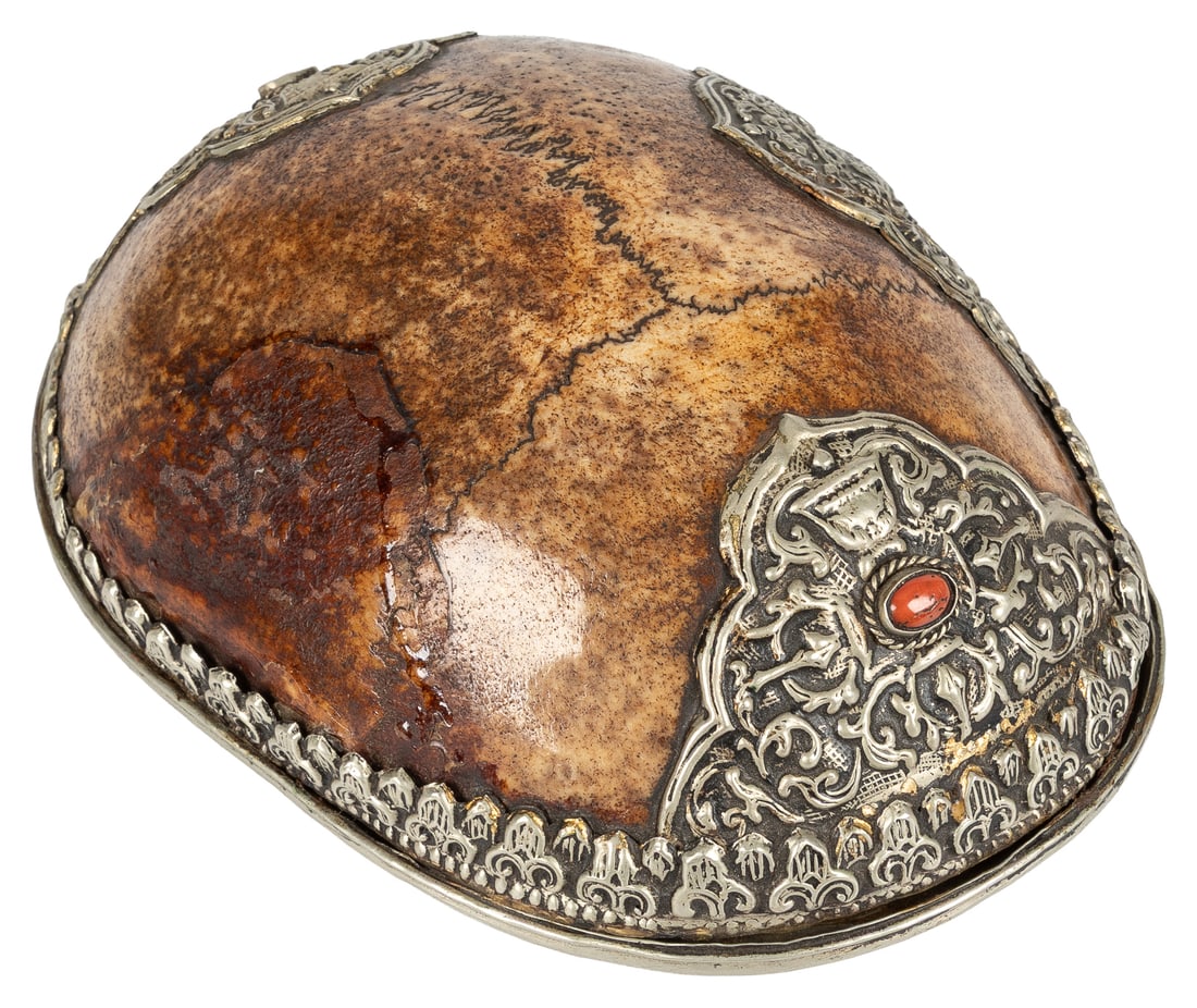 Tibetan Kapala Skull Cap Bowl. Circa 19th century.: Tibetan Kapala Skull Cap Bowl. Circa 19th century. Mounted with decorative metalwork and semi-precious stones. Silver overlay with central dorje and coral inset at base. Ceremonial vessels that serve
