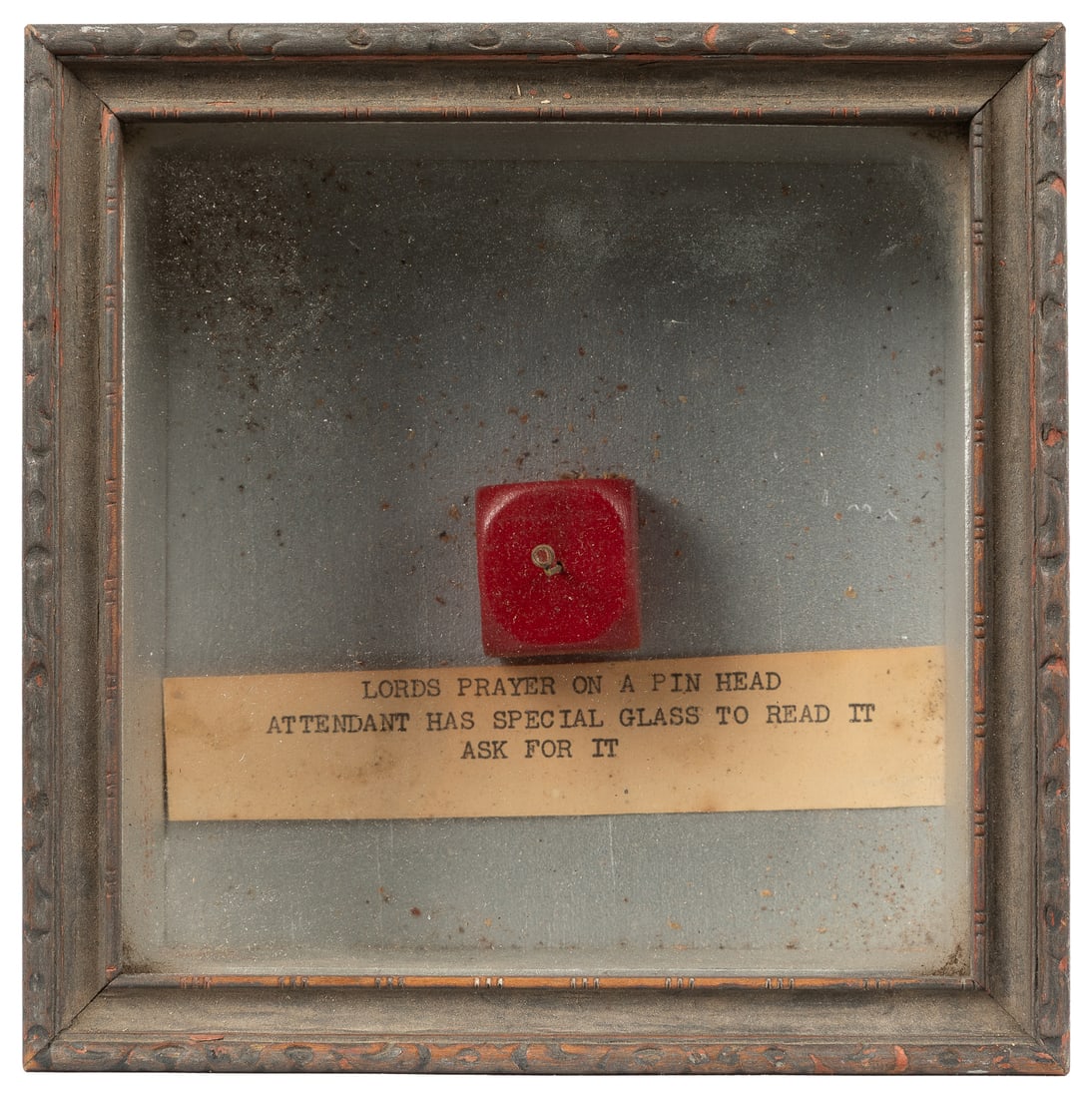 Lord's Prayer on a Pinhead. Circa mid-20th century.: Lord's Prayer on a Pinhead. Circa mid-20th century. From Hubert's Dime Museum, a famous Times Square sideshow (ca. 1925–1969). In a display box with label "Attendant has special glass to read