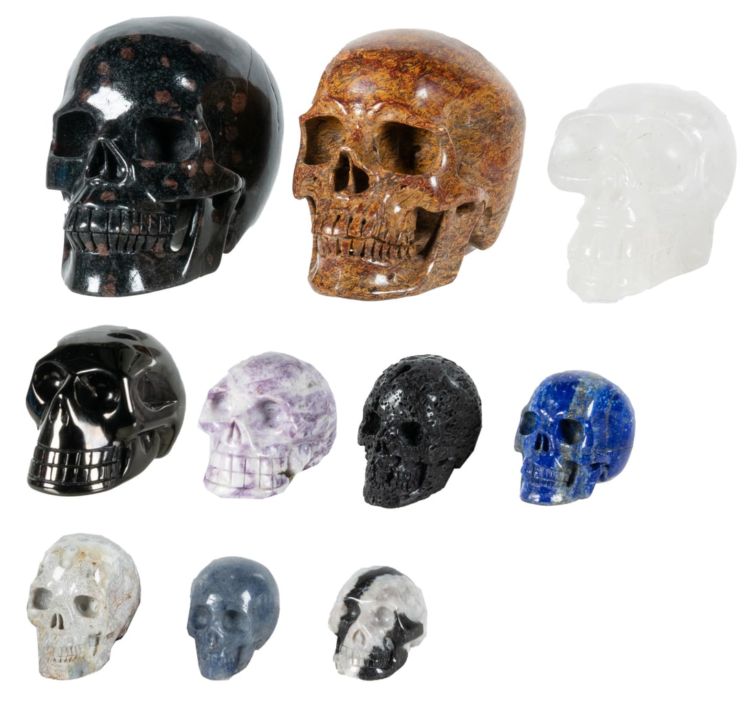 Group of 10 Carved Semiprecious Stone Skulls.: Group of 10 Carved Semiprecious Stone Skulls. Including 3 large (plum blossom jasper, elephant skin jasper, and Himalayan quartz) and 7 smaller (metallic jet, charoite, hot lava stone, crazy lace