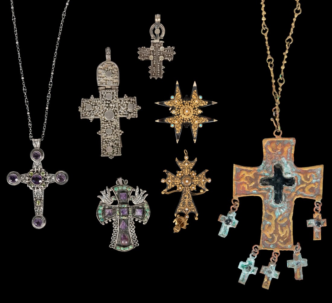 Group of 11 cross pendants or necklaces.: Group of 11 cross pendants or necklaces. Circa 19th / 20th century. A collection of crosses, including silver and gilt filigreed, and other metal, some with inset semi-precious stones, two with