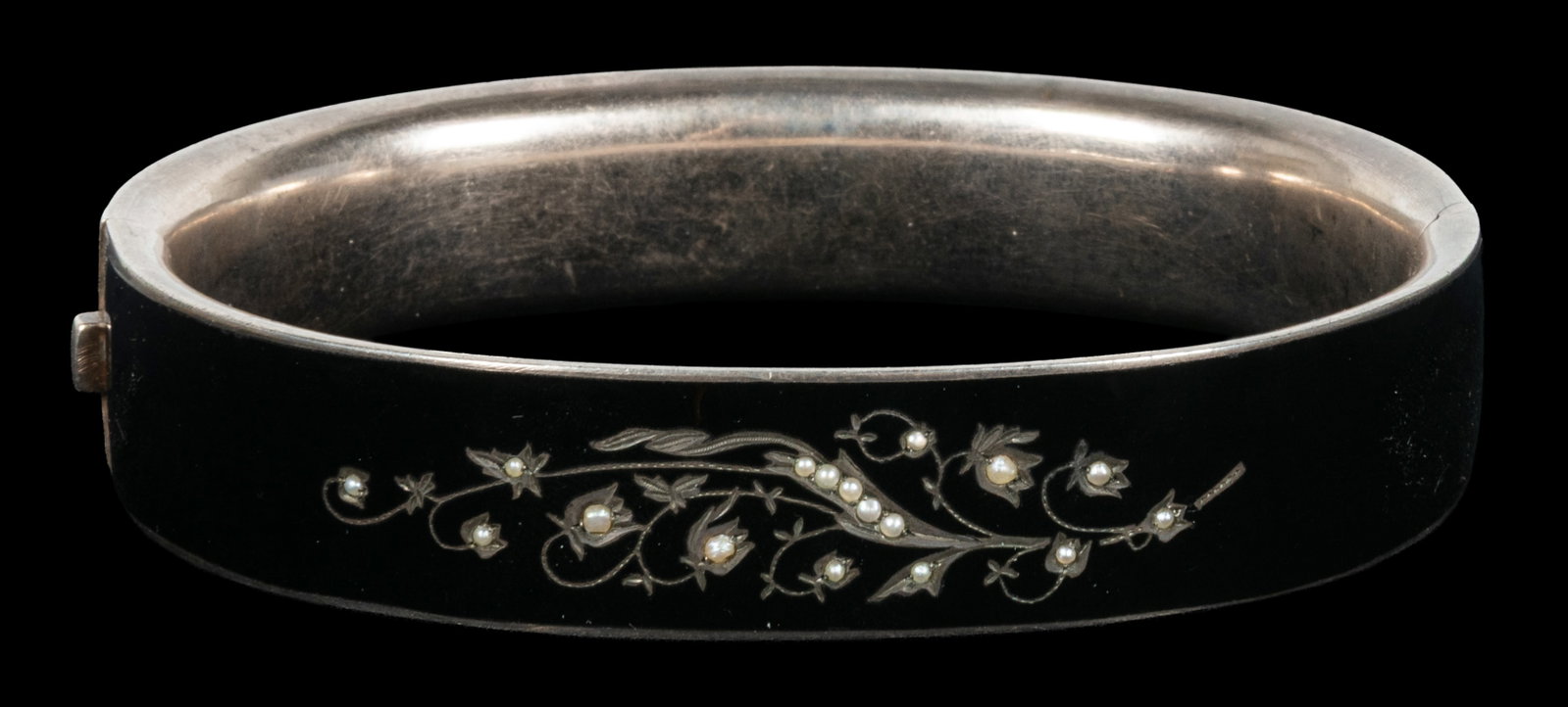 Victorian enamel and pearl mourning bangle.: Victorian enamel and pearl mourning bangle bracelet. 19th century. Hinged black enamel with engraved floral motif, inset seed pearls. Marked "G-A-S / 900". 4 x 3 x 3/4".