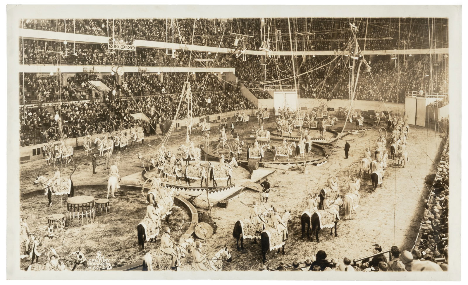 KELTY, Edward J. (1888 - 1967). [Ringling Bros. and Barnum & Bailey]. 1926.: KELTY, Edward J. (1888 - 1967). [Ringling Bros. and Barnum & Bailey]. 1926. New York: Century. Silver print panoramic photograph depicting an elaborate circus procession within an arena. Unusually for