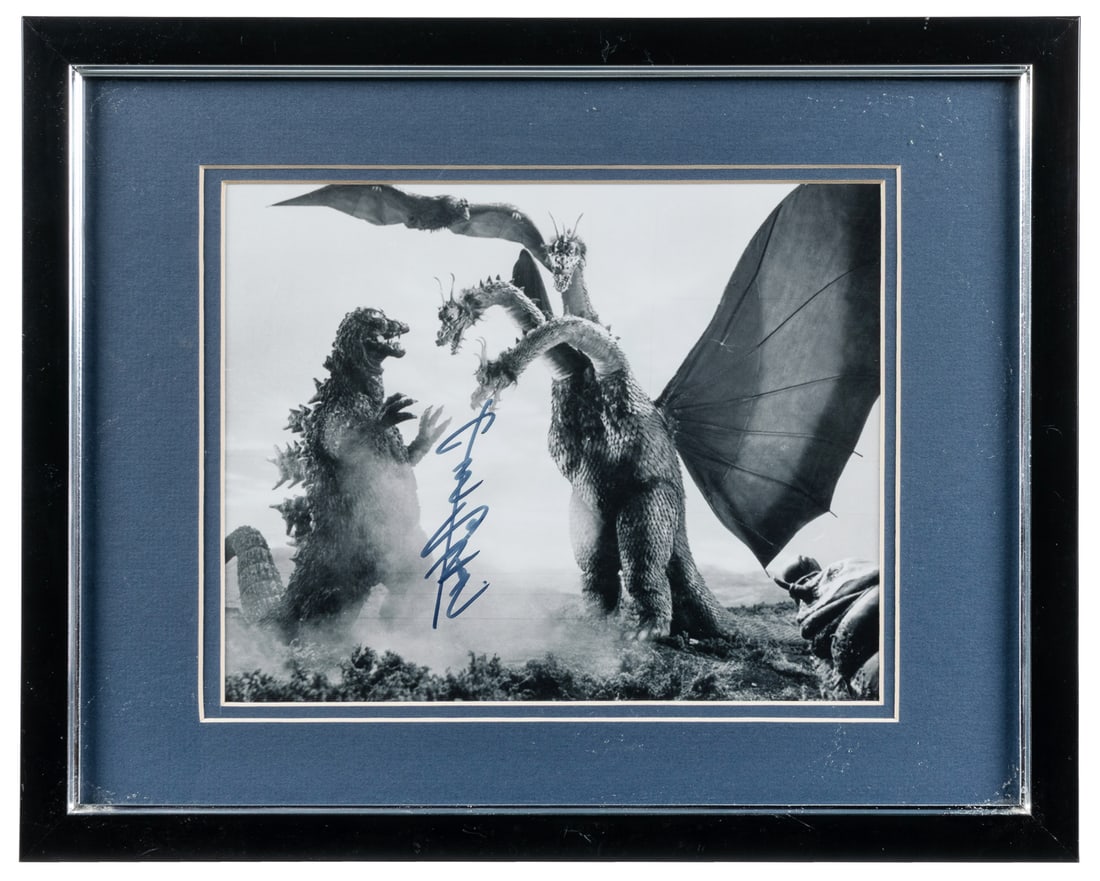 [CINEMA]. [GODZILLA]. Photo Signed by Suit Actor Haruo Nakajima [N.p., ca. 20th century].: [CINEMA]. [GODZILLA]. Photo Signed by Suit Actor Haruo Nakajima. [N.p., ca. 20th century]. Black and white photo of Godzilla fighting King Ghidorah, with Mothra and Rodan looking on, most likely from