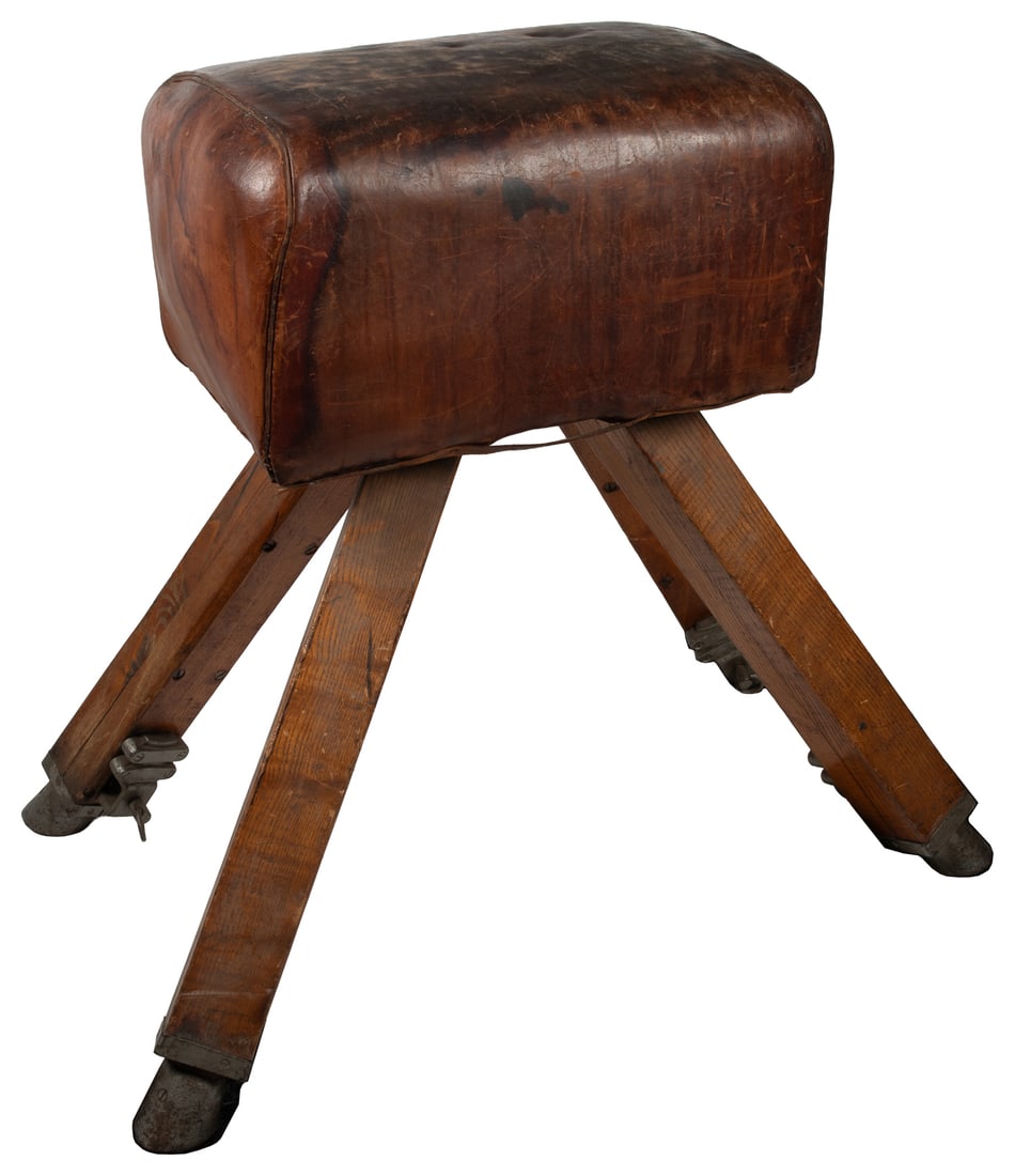 Leather Pommel Horse. Circa early/mid-20th century.: Leather Pommel Horse. Circa early/mid-20th century. Brown leather with wood and metal frame and legs. Height approximately: 36". Customer pickup or third-party shipping required.