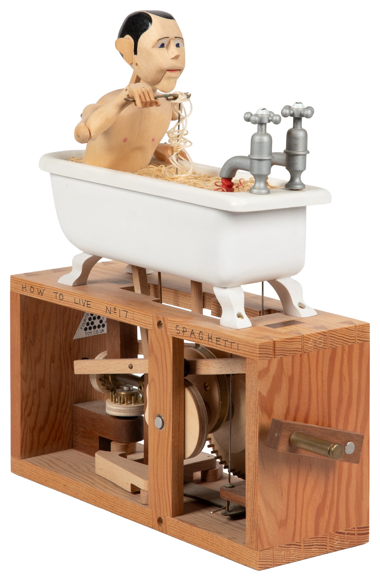 How to Live No. 17: Spaghetti Automaton.: How to Live No. 17: Spaghetti Automaton. England: Fourteen Balls Toy Co. / Matt Smith, ca. 2000s. As the crank is turned, the figure seated in the bathtub raises a forkful of pasta to his mouth and