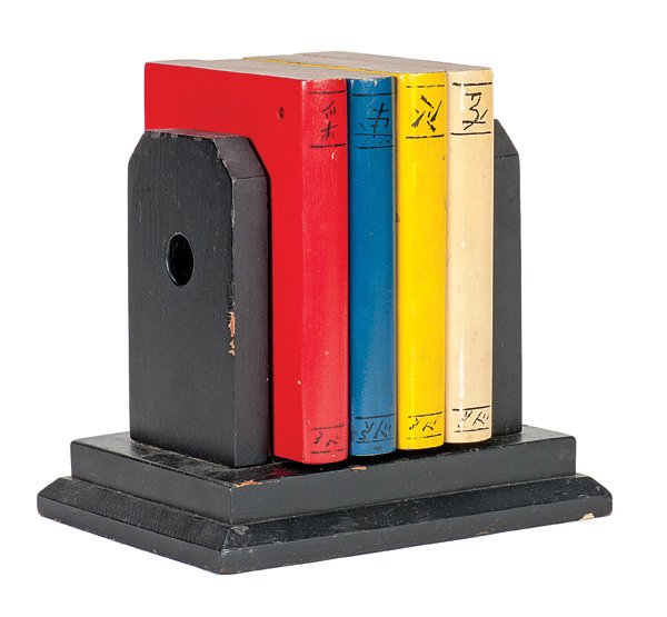 21. Books of Ching Soo. Petrie & Lewis, ca. 1930.: 21. Books of Ching Soo. New Haven, Petrie & Lewis, ca. 1930. Four faux wooden books are tied through a set of wooden bookends by passing a ribbon through them. The books then penetrate the ribbon visi