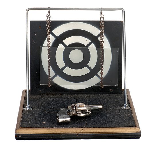 24. Improved Bullet Proof Girl. Abbott’s, ca. 1950.: 24. Improved Bullet Proof Girl. Colon Michigan, Abbott’s Magic, ca. 1950. A girl stands in front of a sheet of glass suspended from two chains, which, in turn is in front of a painted wooden target.