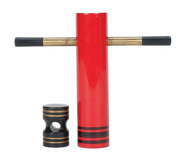 327. Bomba Atomica. Holland, Eddy Taytelbaum, ca. 1970.: 327. Bomba Atomica. Holland, Eddy Taytelbaum, ca. 1970. A cylindrical wooden block is locked inside a tube with a brass magic wand, then penetrates the wand. Red tube 5 ¼” high. Wand shows wear. Ve