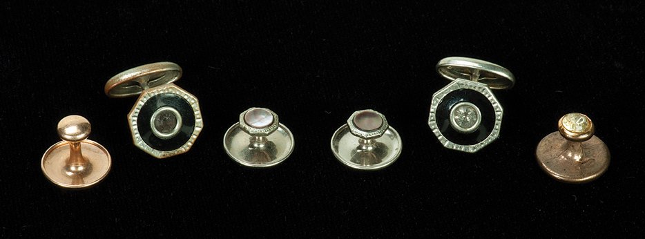 352. Dante’s matching cuff links and studs.: 352. Dante. Dante’s cuff links and studs. Set of matching metal cuff links with inset rhinestones and four shirt studs, the lot worn and used by the famous Danish-American magician Dante (Harry Augu