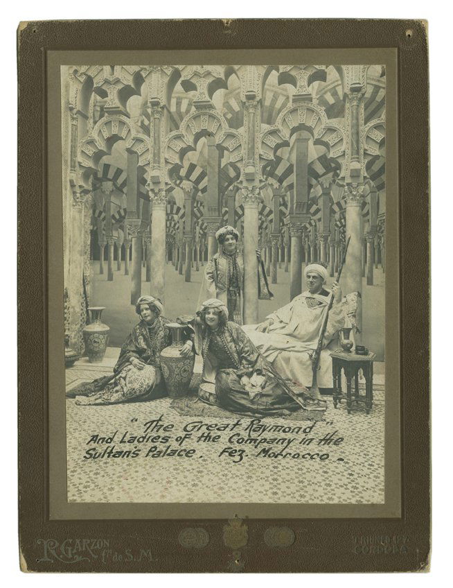 Photograph of The Great Raymond in Morocco.: The Great Raymond (Raymond Saunders). Photograph of The Great Raymond in Morocco. Cordoba, R. Garzon photographer, ca. 1910. Boudoir card format, showing Raymond and three women from his cast dressed